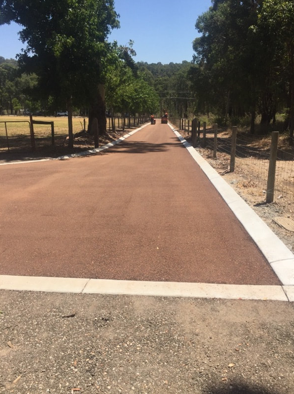 This is a photo of a hot spray & seal bitumen roadway which is in the process of being installed by Goulburn Road Tek
